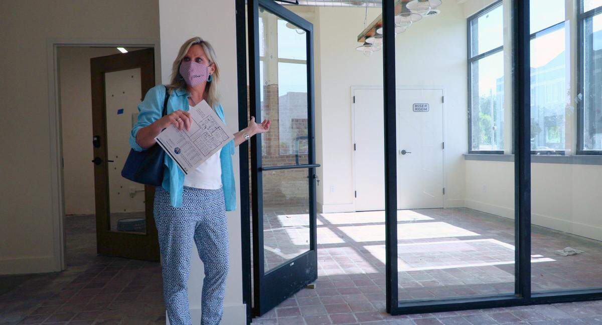 Leah Braxton, associate broker with W.C. Bradley Real Estate, gives a tour of Bibb City Offices & Lofts, located at 3707 2nd Avenue in Columbus, Georgia. They feature private offices in a coworking environment, residential lofts, and one warehouse space. Here she is describing one of the offices.
