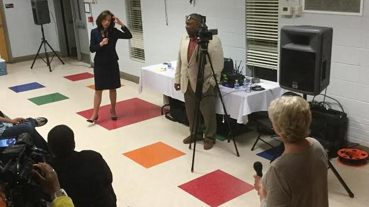 Mayor Teresa Tomlinson , at left, helps Lisa Jenkins with a question about prison inmates and garbage.