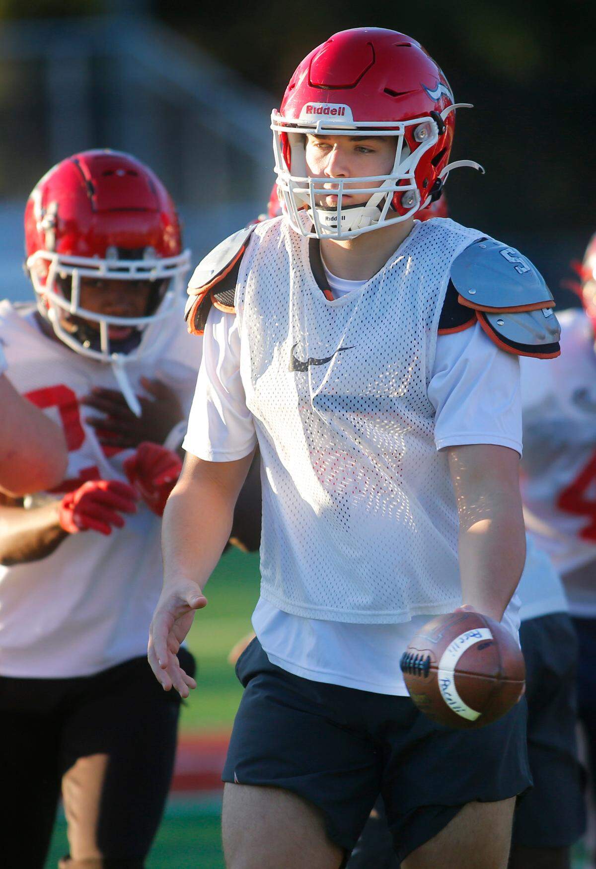 St. Anne-Pacelli senior quarterback Cam Ellis, right, runs a drill during practice on Wednesday. 11/30/2022