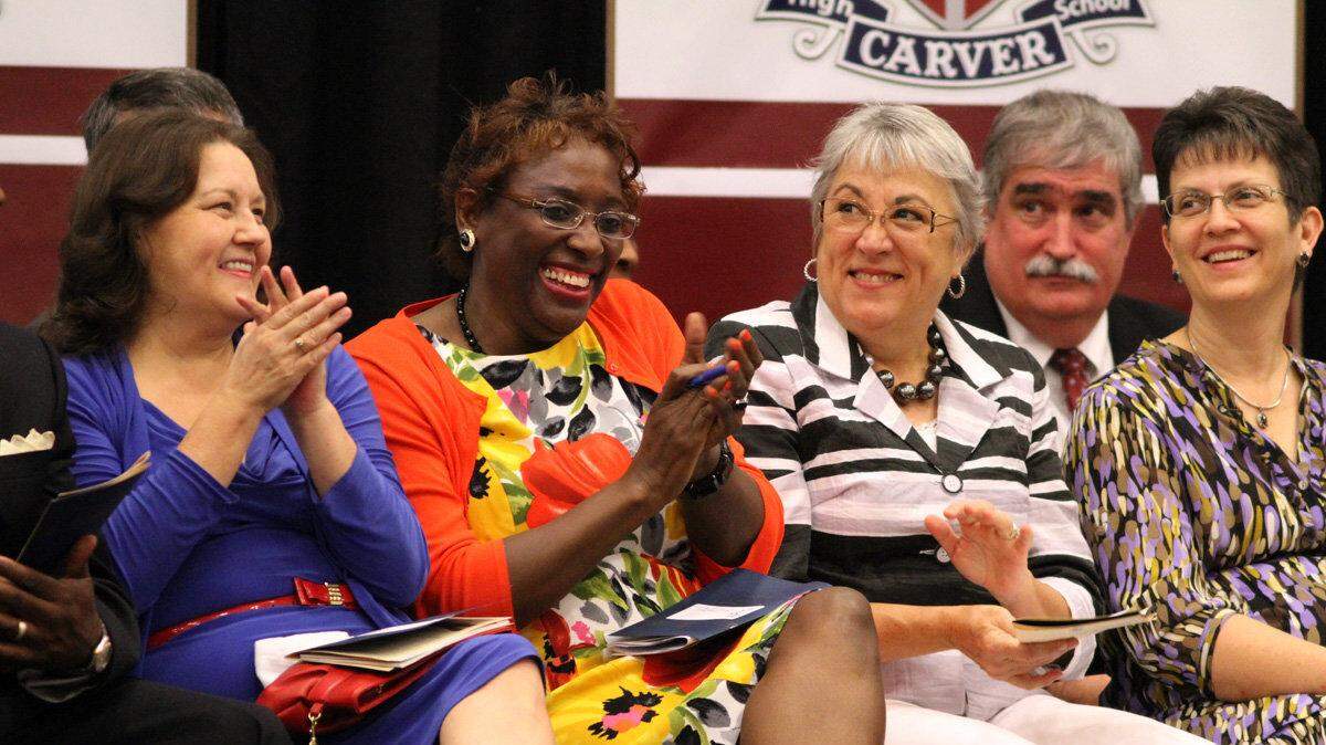 MIke Haskey mhaskey@ledger-enquirer.com
Muscogee County School Board members Beth Harris, Naomi Buckner, Cathy Williams and Norene Marvets applauds comments from the podium  Saturday afternoon for the dedication ceremony of the new George Washington Carver High School. 09/01/12