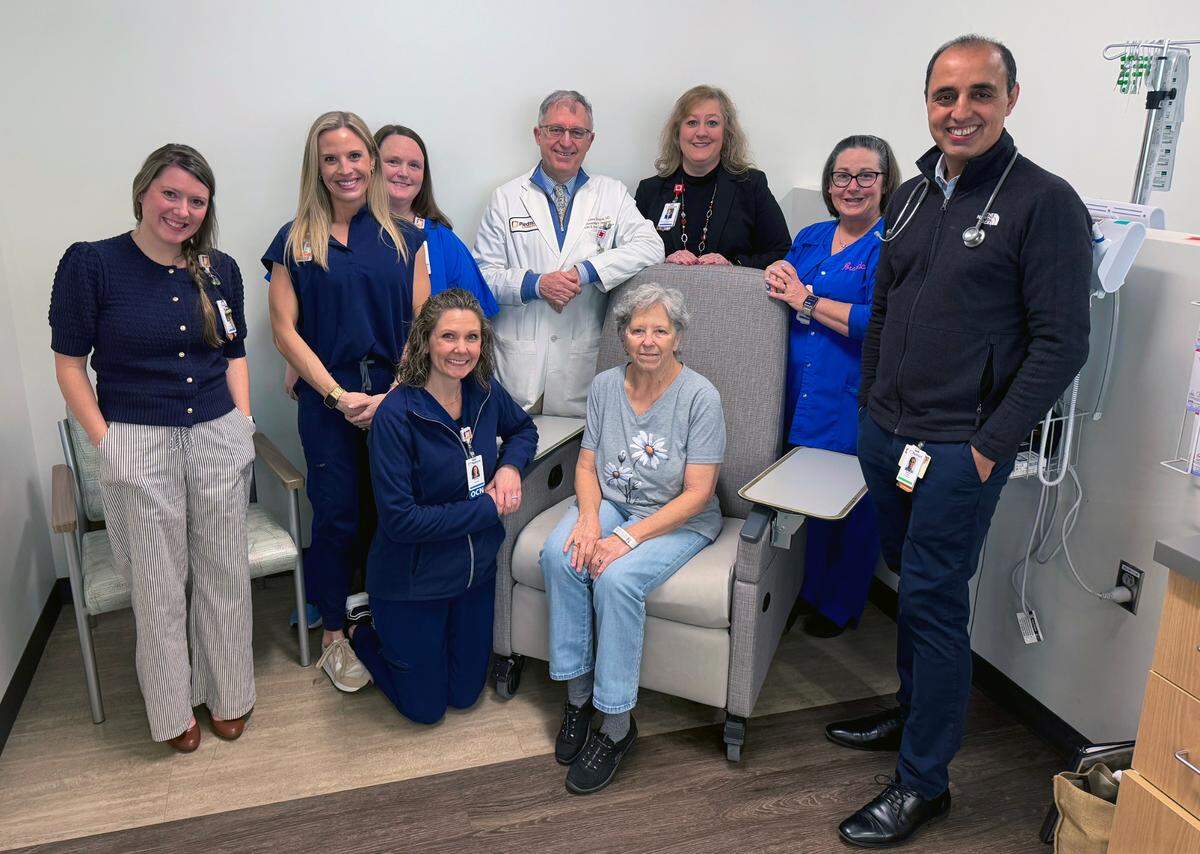 Susan Williams,seated center, a patient at the John B. Amos Cancer Center in Columbus, Georgia, is receiving a new cancer treatment known as Bispecific T-Cell Engager (BiTE) therapies on Feb. 11, 2025. Here, she is photographed with some of her care providers.