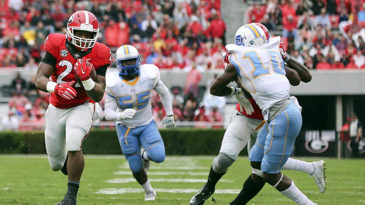 JOHN BAZEMORE/Associated PressGeorgia running back Nick Chubb (27) runs away from Southern's Kentavious Preston (55) and Danny Johnson (10) for a touchdown in the first half of an NCAA college football game Saturday in Athens, Ga.