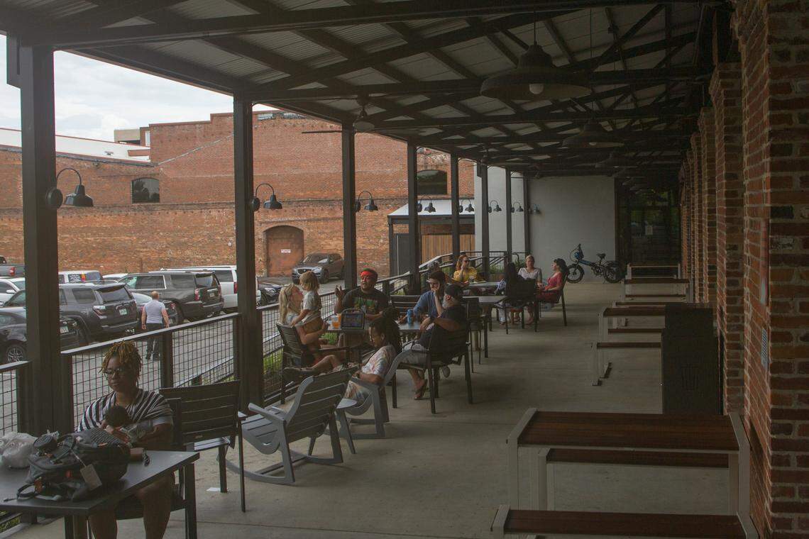 Customers relax on the outside patio at Banks Food Hall, 1002 Bay Avenue, in Columbus, Georgia, on June 28, 2021.