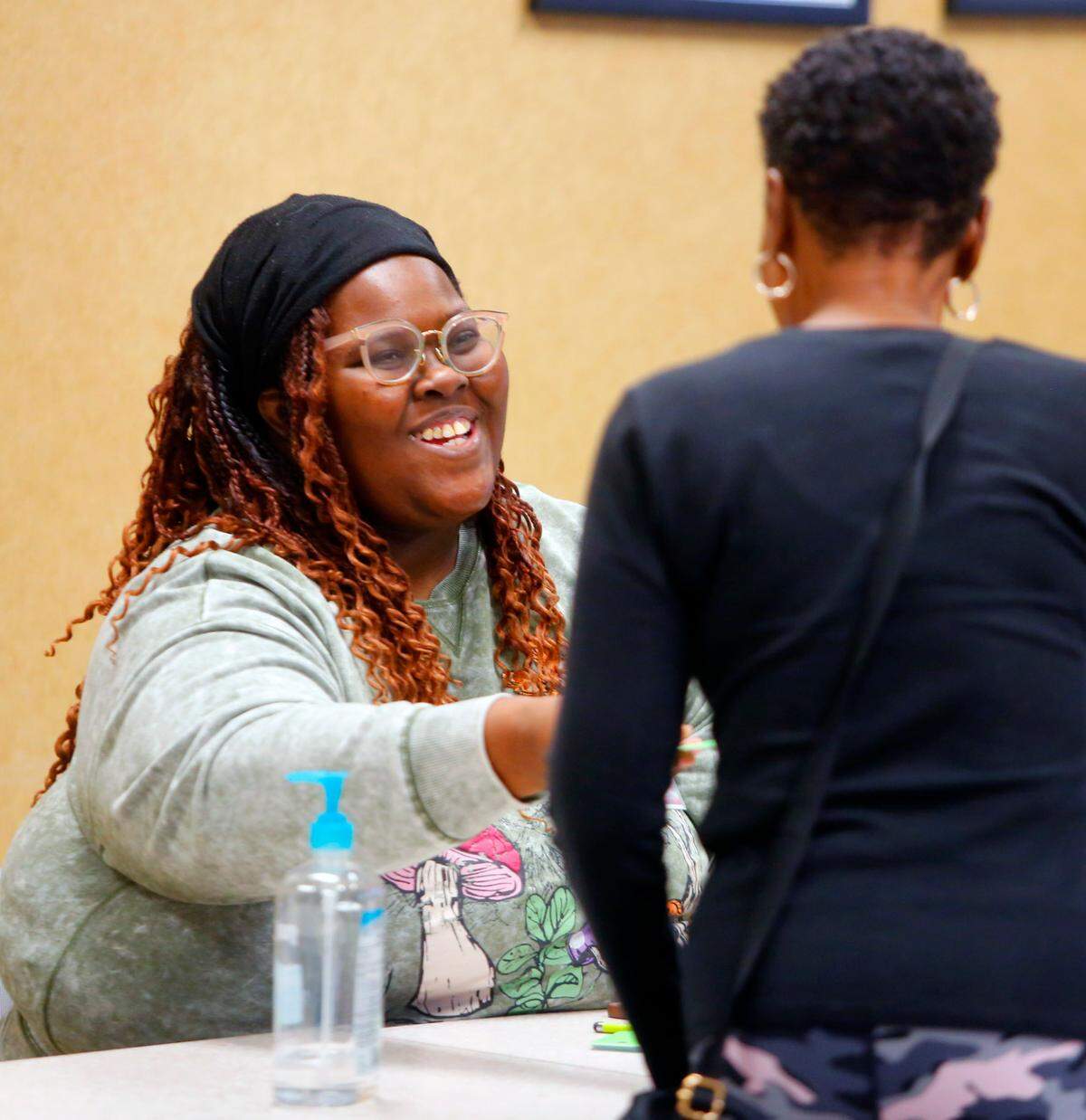 Shinaicia Jones, a poll worker at the voting precinct at Columbus Technical College, hands a voter their voting card Tuesday. 11/05/2024
