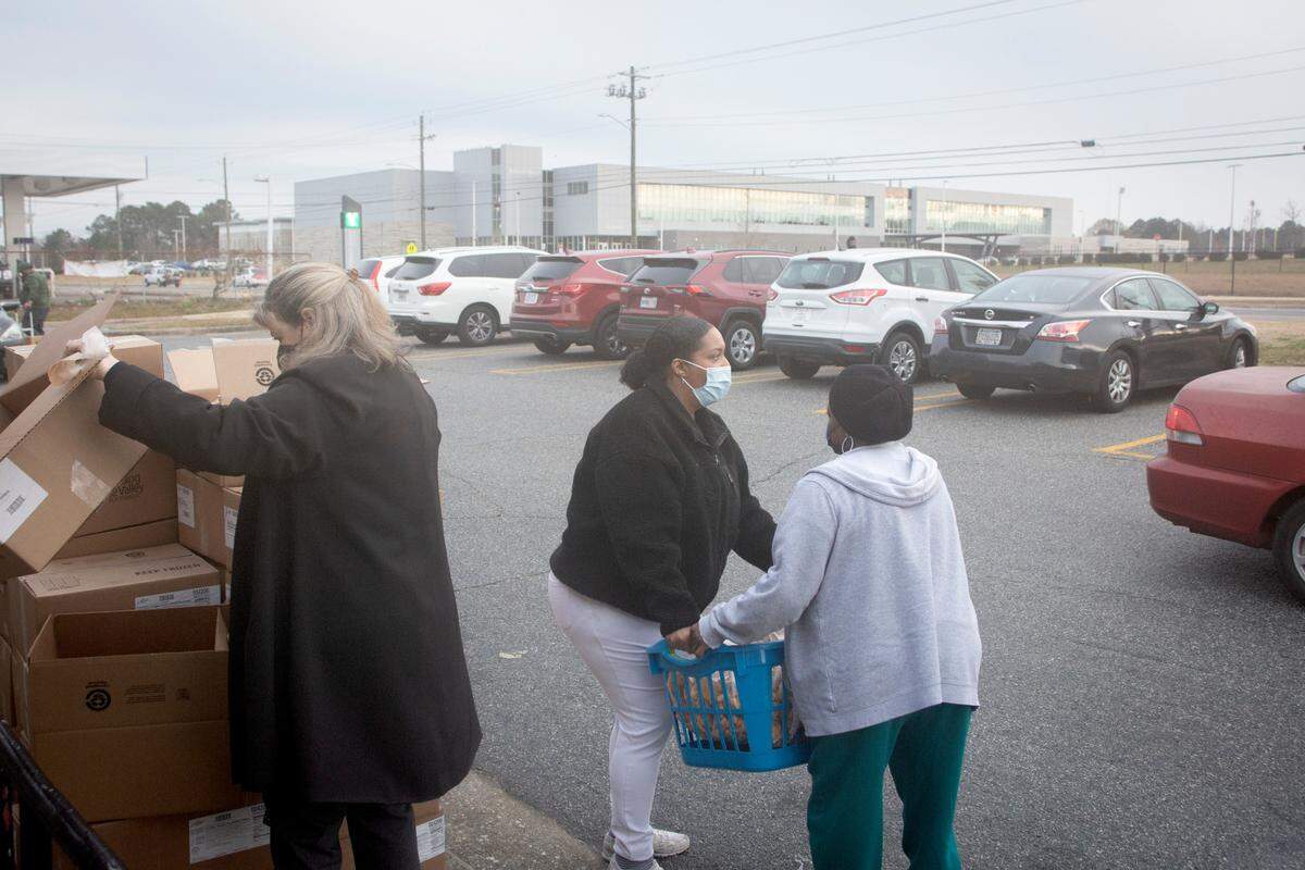 E.J. Knight Senior Center manager Myrtis Boddy distributes food to local seniors at a Feeding the Valley mobile pantry site in Columbus, Ga. on Jan. 25, 2022.