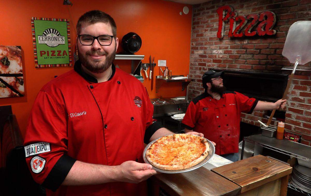 Leo DiCesaris, owner of Cerrone’s Brick Oven Pizzeria in Columbus, holds a New York style cheese pizza made in the restaurant. DiCesaris was the winner of the best non-traditional pizza from the Southeast Region in the International Pizza Challenge at the International Pizza Expo, held in early March in Las Vegas, Nevada.