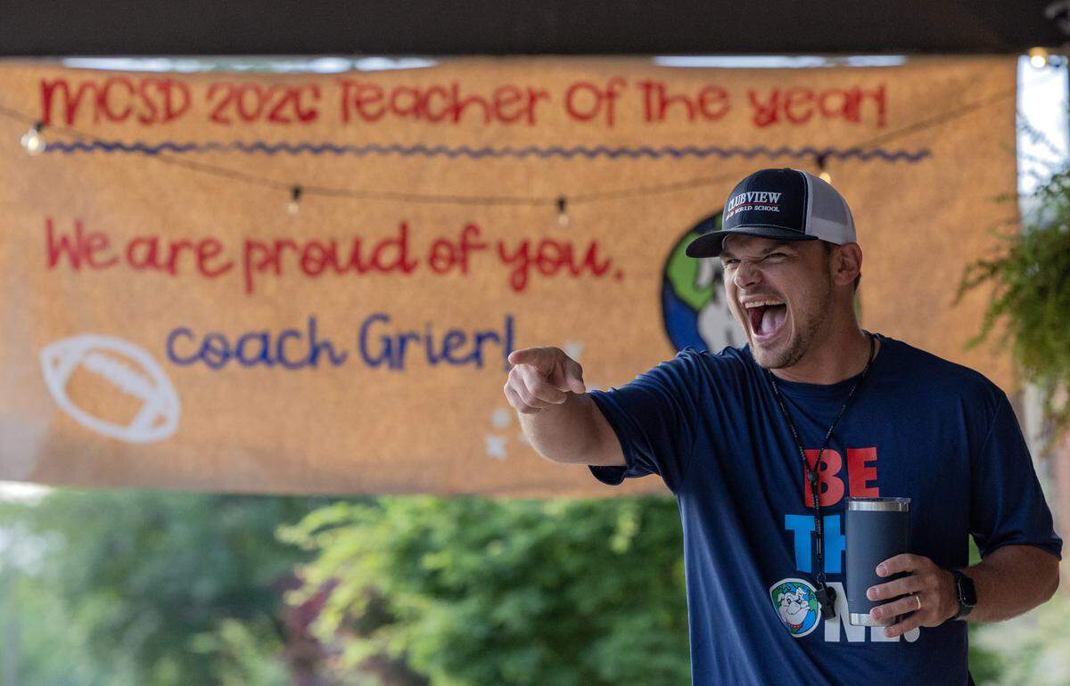 Clubview Elementary School physical education teacher Chris Grier greets students arriving for school May 8, 2026, the day after the Muscogee Educational Excellence Foundation named him the 2026 Teacher of the Year in the Muscogee County School District.