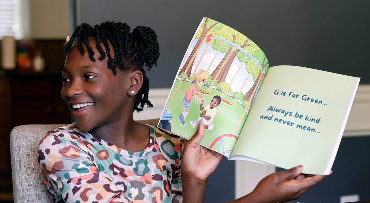 Morgan Murrell reads an excerpt of “G is for Gymnasts and So Much More” which she authored with her sister Cydney Murrell in Phenix City. 05/28/2025