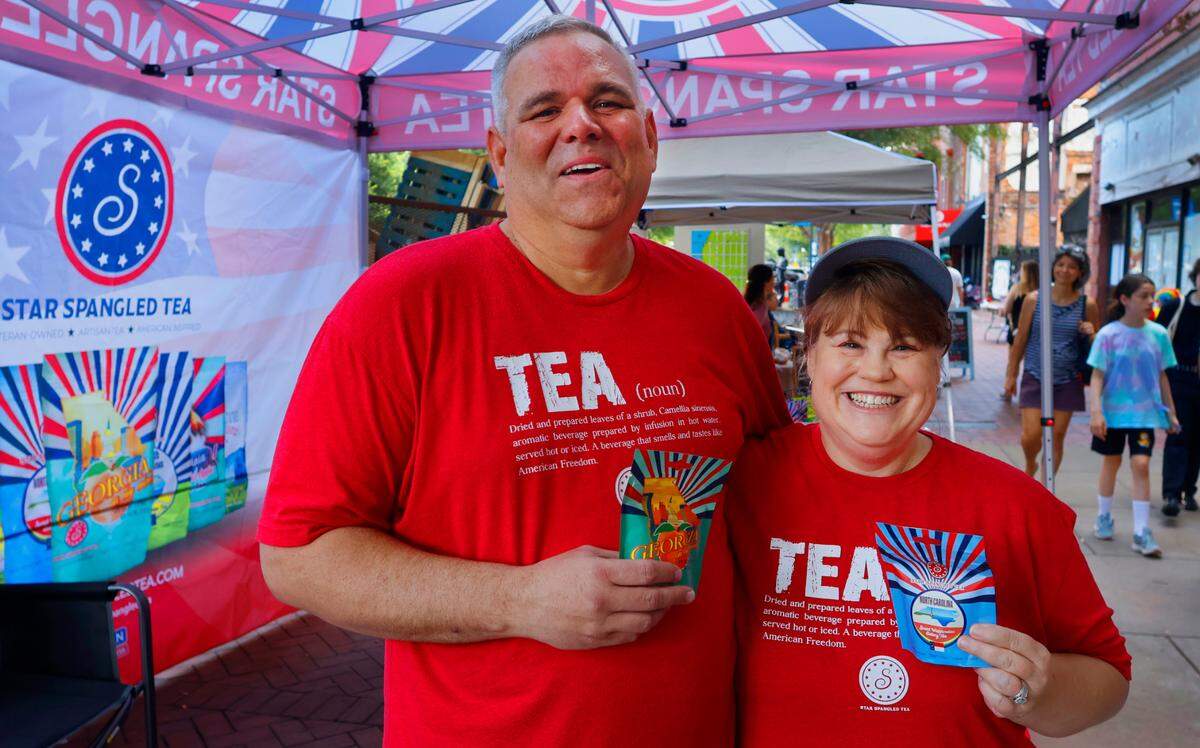 Roger and Aimee Owens, the owners of Star Spangled Tea, take a moment to pose for a photograph while selling their tea at a recent Market Days on Broadway in Columbus, Georgia. 06/29/2024