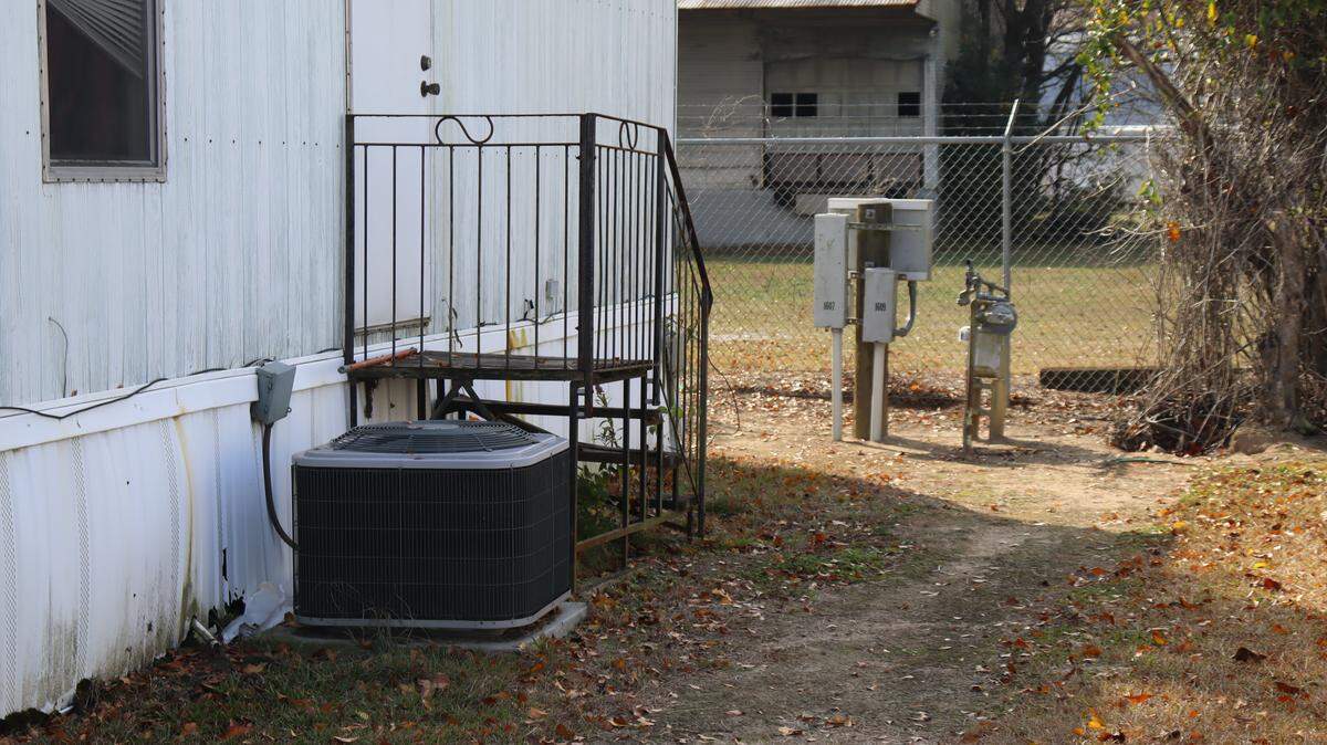 Jessica Smith's air conditioning unit and utility energy meter.