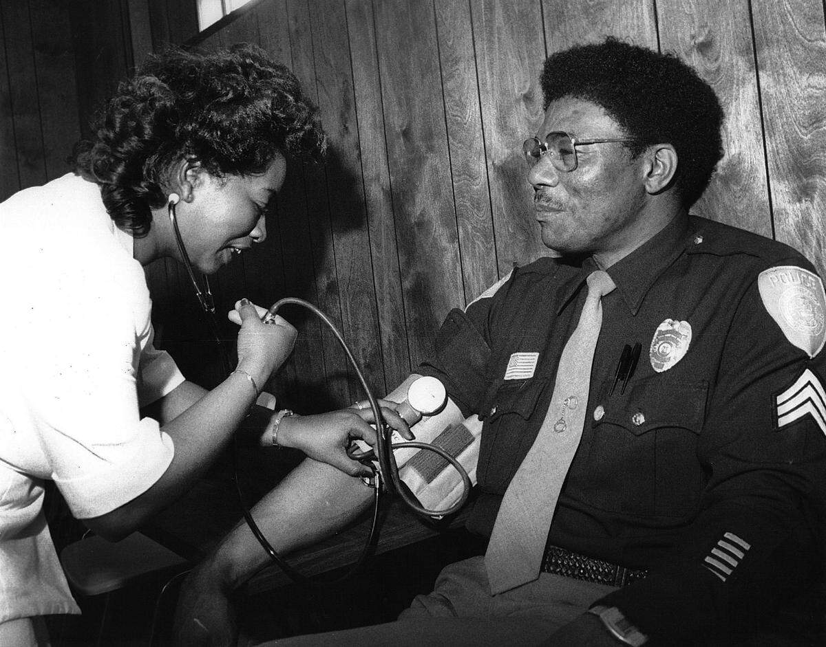 Columbus Police Sgt Joe Robbins has his blood pressure checked by Beverly Smith, a registered nurse.