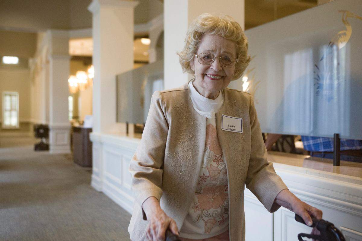 Lucile Lambert goes to greet guests before a luncheon to celebrate her birthday and scrapbooks on June 9, 2021, at Spring Harbor at Green Island in Columbus, Ga. The three scrapbooks were presented to Columbus State University to live in their archive.