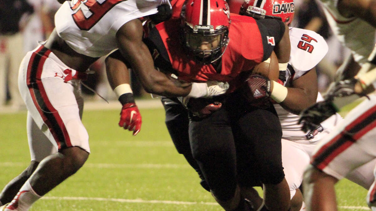 ROBIN TRIMARCHI rtrimarchi@ledger-enquirer.comCentral High running back Jaxton Carson is hit by the Opelika defense in first half play at Garrett-Harrison Stadium Friday.  09.25.15