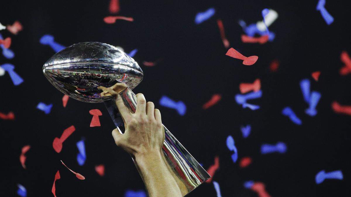 FILE - In this Feb. 5, 2017, file photo, New England Patriots’ Tom Brady holds up the Vince Lombardi Trophy after winning the NFL Super Bowl 51 football game against the Atlanta Falcons in Houston. The NFL’s inexorable trend of going younger and cheaper does not bypass the best in the league. No team does it with quite the high-profile zeal as the Patriots, who have collected five Super Bowl titles since 2002, and will be going for No. 6 on Sunday, Feb. 3, 2019, against the Rams. (AP Photo/Jae C. Hong, File)
