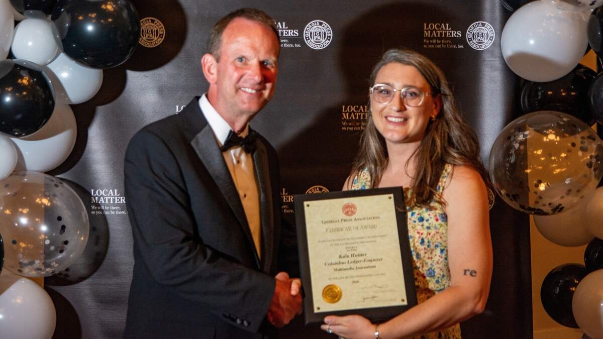 Georgia Press Association president Keith Barlow presents Ledger-Enquirer reporter Kala Hunter with her first-place award for multimedia journalism in the GPA’s Better Newspaper Contest at its annual convention June 12, 2026, on Jekyll Island.