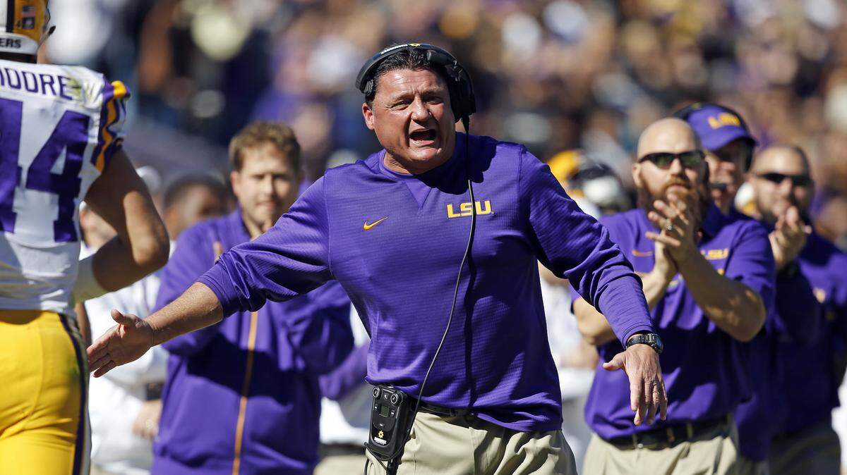 In this Nov. 19, 2016, file photo, LSU interim head coach Ed Orgeron cheers from the sideline after a score in the first half an NCAA college football game against Florida in Baton Rouge, La.