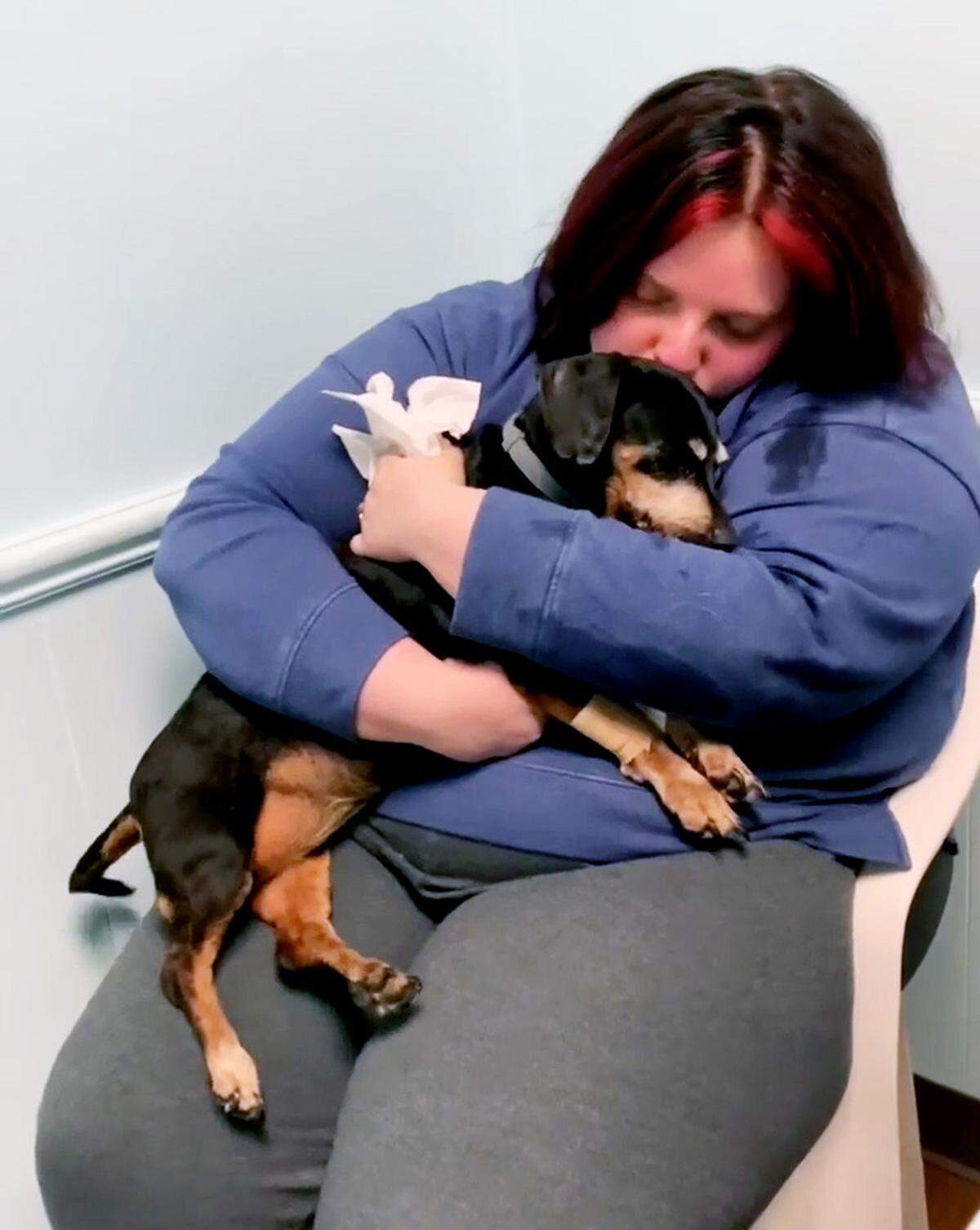Loren Vanpelt holds Penny during a visit to a veterinarian’s office after the alleged assault upon Penny.