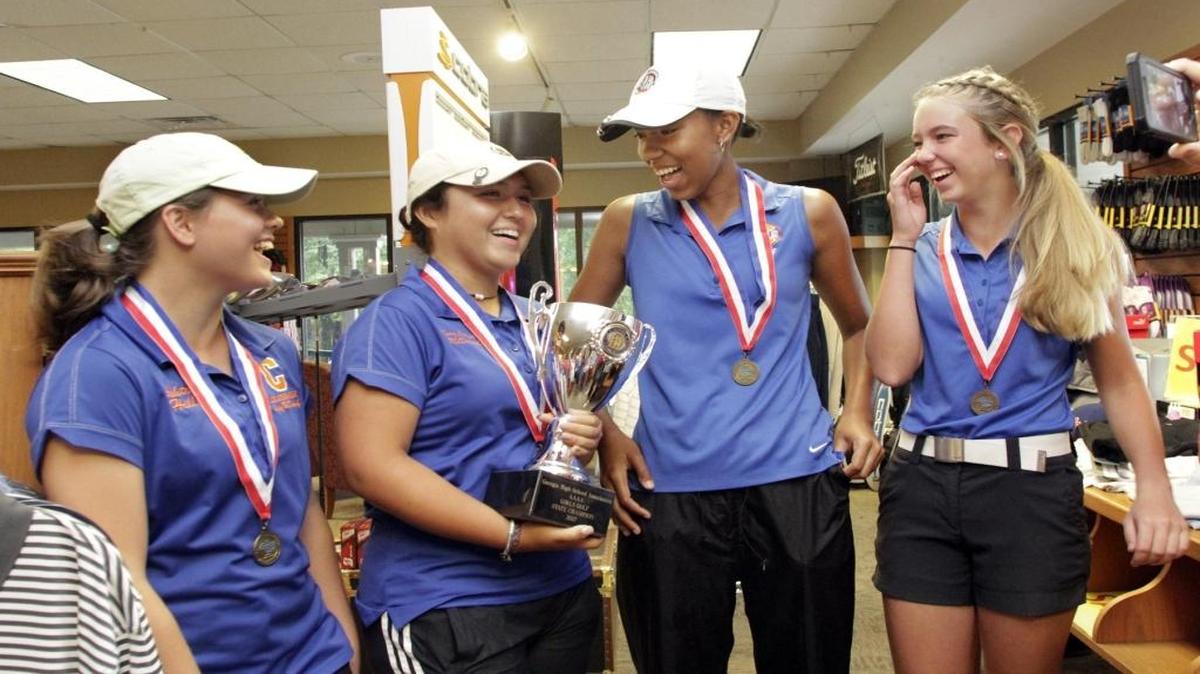 Columbus’ Mary Catherine McDaniel (holding trophy) posted her best score at the state tournament to help the Lady Blue Devils capture their ninth state title in program history.