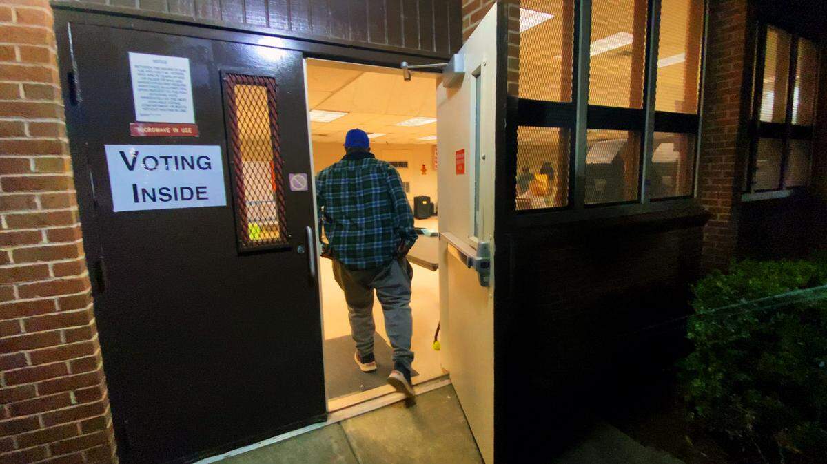 A voter rushes into the voting precinct inside the Gallops Senior Center in Colmbus, Georgia minutes before the polls closed at 7 p.m. EST. 11/05/2024