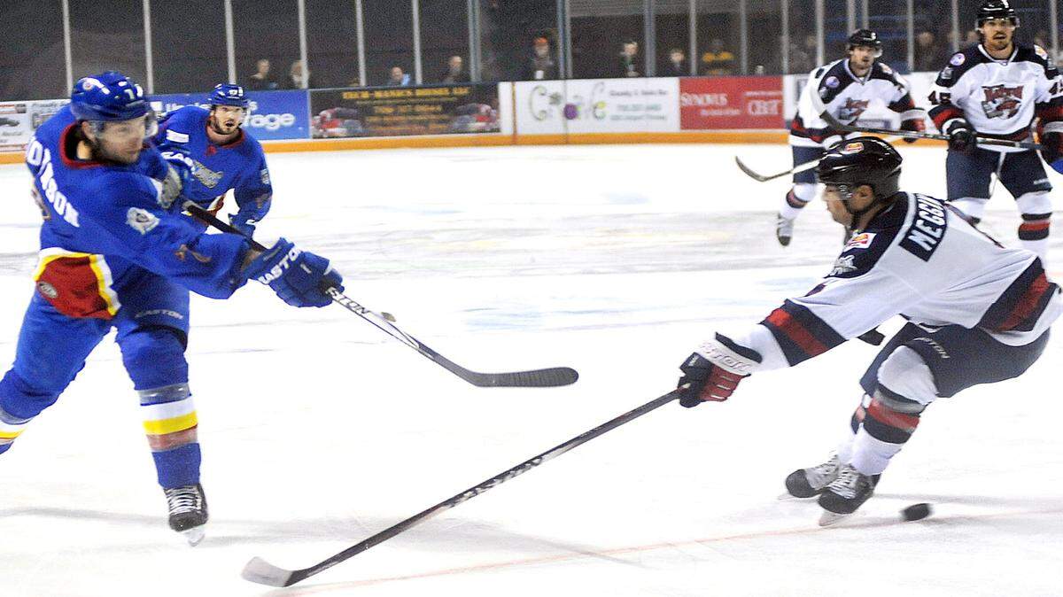 DARRELL ROADEN/Special to the Ledger-EnquirerColumbus' Ben O'Quinn fires the puck past Macon's Mark McGowan in the first period Saturday night at the Columbus Civic Center.