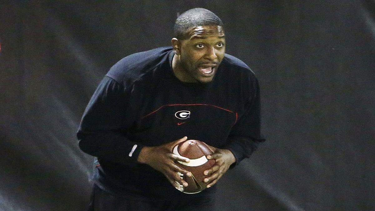 DAVID GOLDMAN/Associated PressGeorgia interim head coach Bryan McClendon runs a drill Wednesday in Athens, Ga., during practice ahead of the TaxSlayer Bowl game against Penn State.