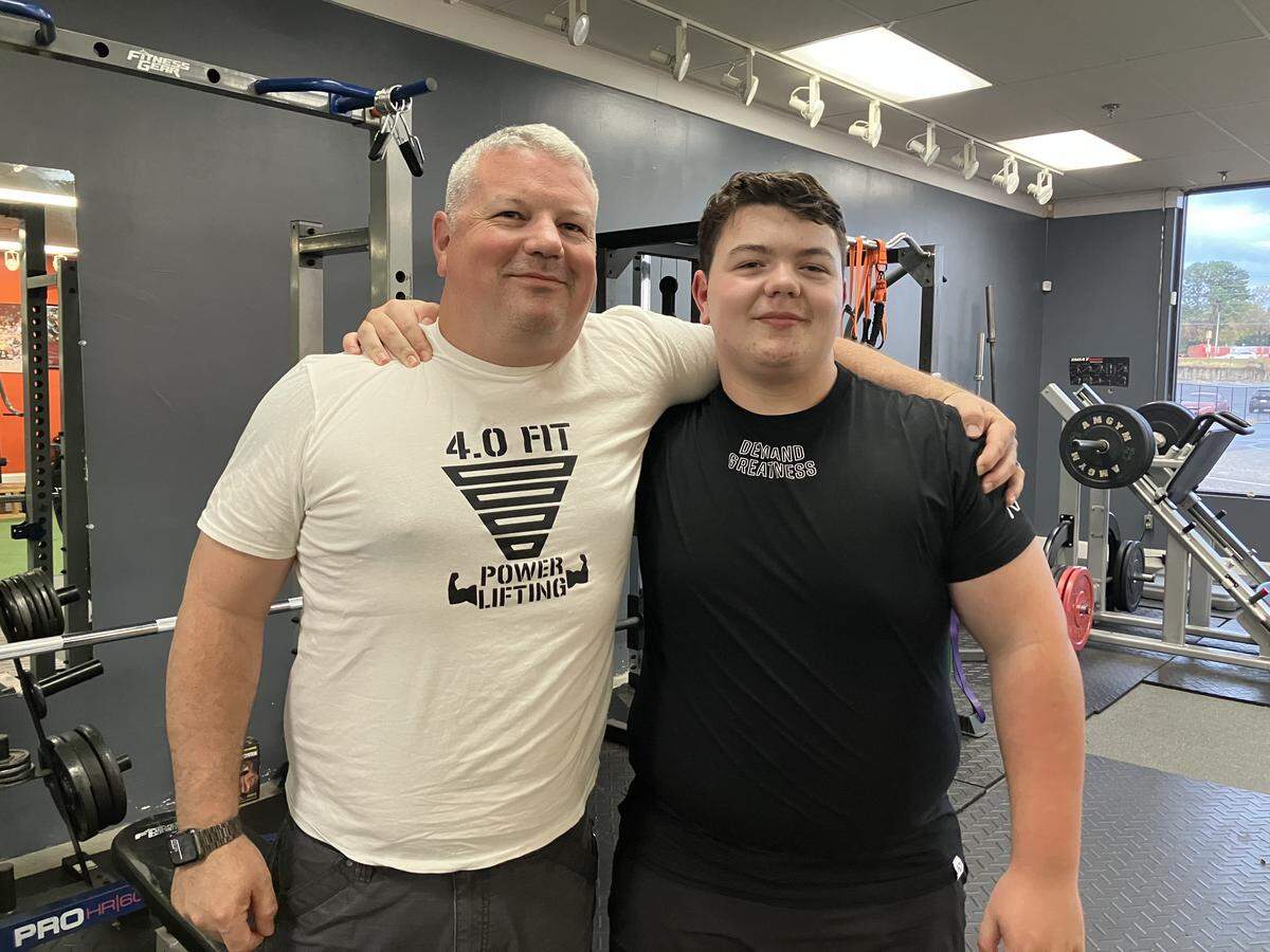 Nash Earwood, right, poses Nov. 7, 2025, with his father, Ryan Earwood, at 4.0 Fitness, 4701 Buena Vista Road in Columbus. Nash set three state records for 12-year-olds Sept. 13 at the USA Powerlifting event in Ringgold, Georgia.