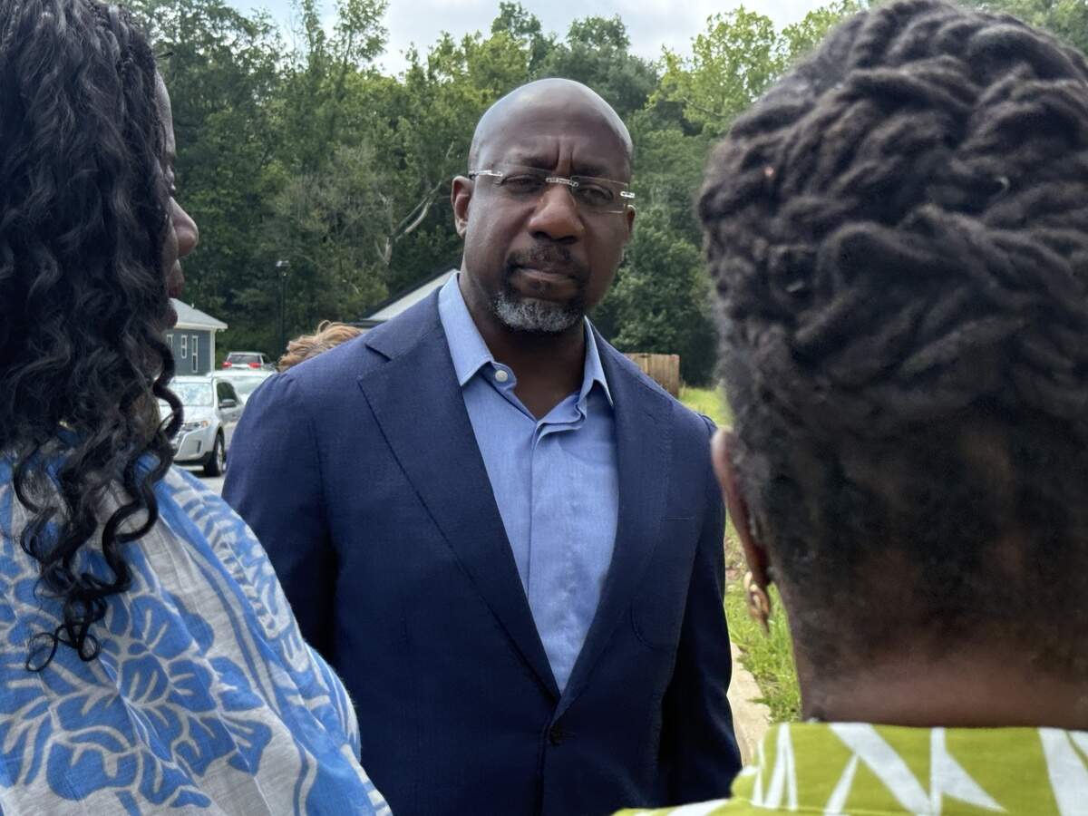U.S. Sen. Raphael Warnock (D-Ga.) speaks to representatives from NeighborWorks Columbus during his July 6, 2026, tour of Elliott’s Walk and sites of upcoming housing developments in Columbus.