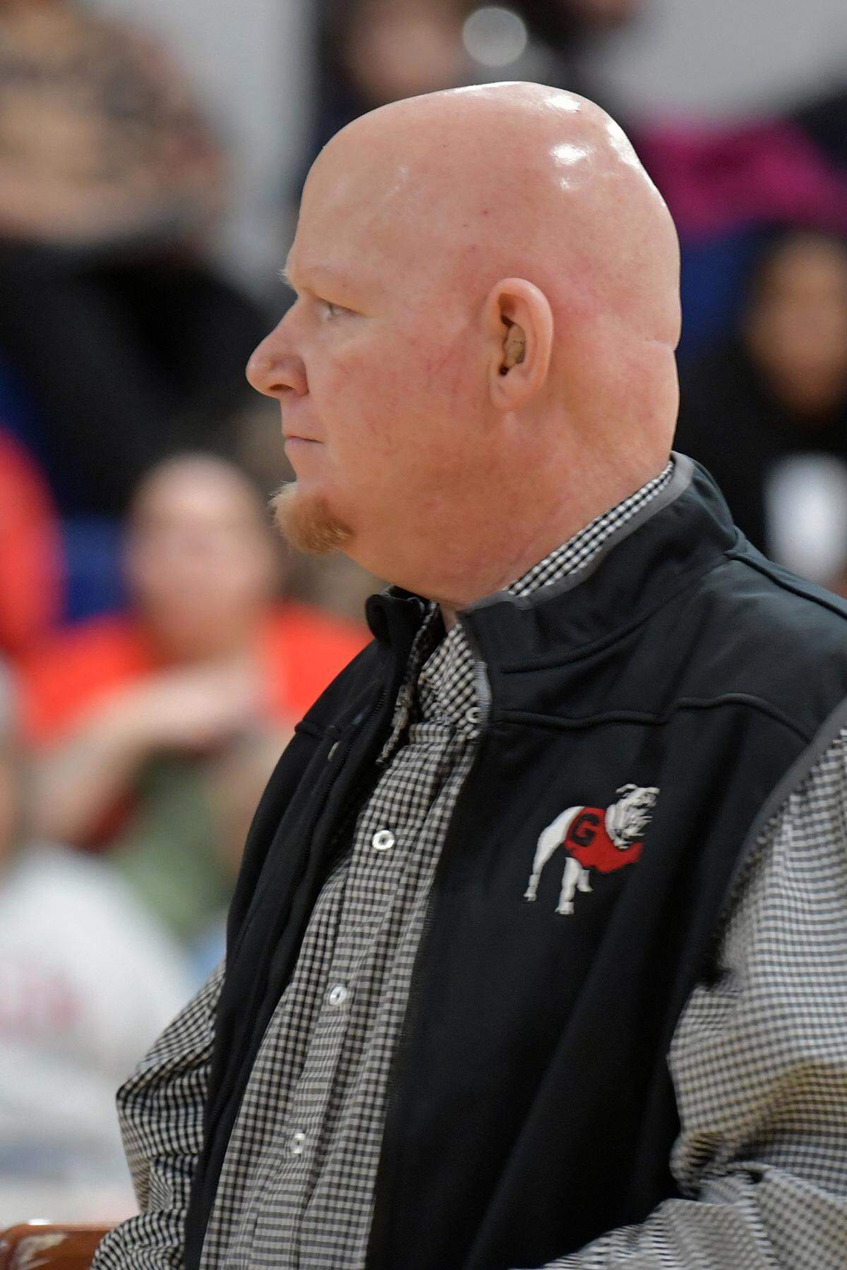 Coach Jay Wilson of Veterans Memorial Middle School in Columbus, Georgia greets guests, family and dignitaries for the dedication ceremony naming the school gymnasium’s court in his honor. 01/24/2024