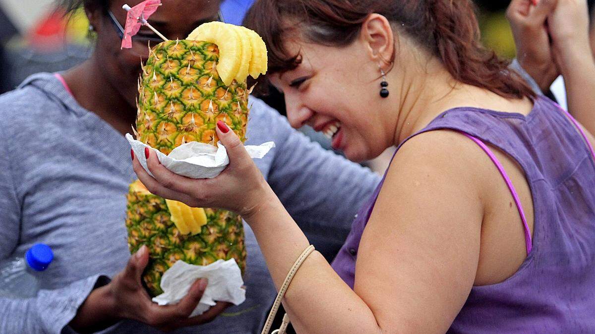 MIKE HASKEY/mhaskey@ledger-enquirer.comMercedes Branch, left, and Maria Badillo enjoy the music and large tropical drinks on Sept. 21, 2013, during the first Tri-City Latino Festival at South Commons in Columbus. The family-friendly event, sponsored by the cities of Columbus and Phenix City and supported by Fort Benning, featured music, entertainment, a kids zone, food and gift vendors and a 5K run.