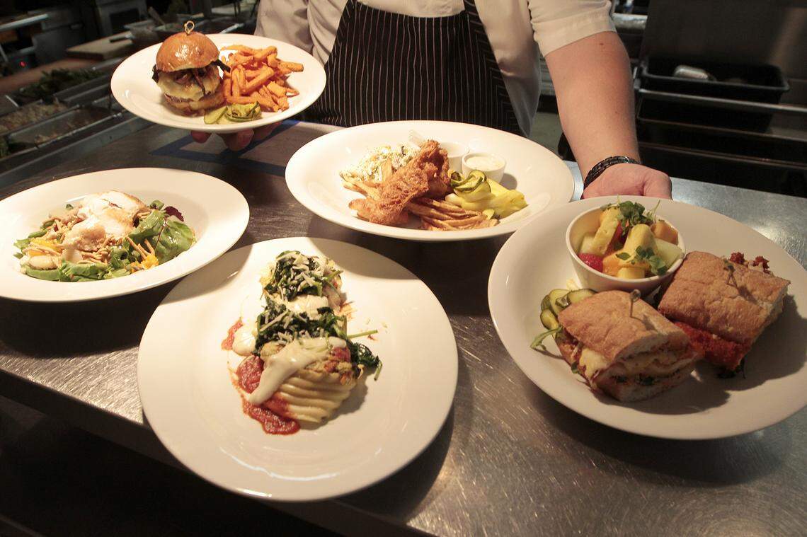 In addition to a dinner menu, Epic Restaurant is featuring five lunch entrees for Restaurant Week 2018, clockwise from left: Grilled Pecan Chicken Salad, Adam’s (Buffalo) Burger, Fish & Chips, Spicy Chicken Panini and Vegetable Lasagna.