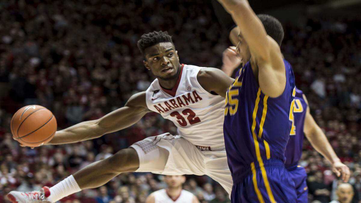 VASHA HUNT/AL.com via APAlabama guard Retin Obasohan passes around LSU forward Ben Simmons during the game Saturday at Coleman Coliseum in Tuscaloosa, Ala.