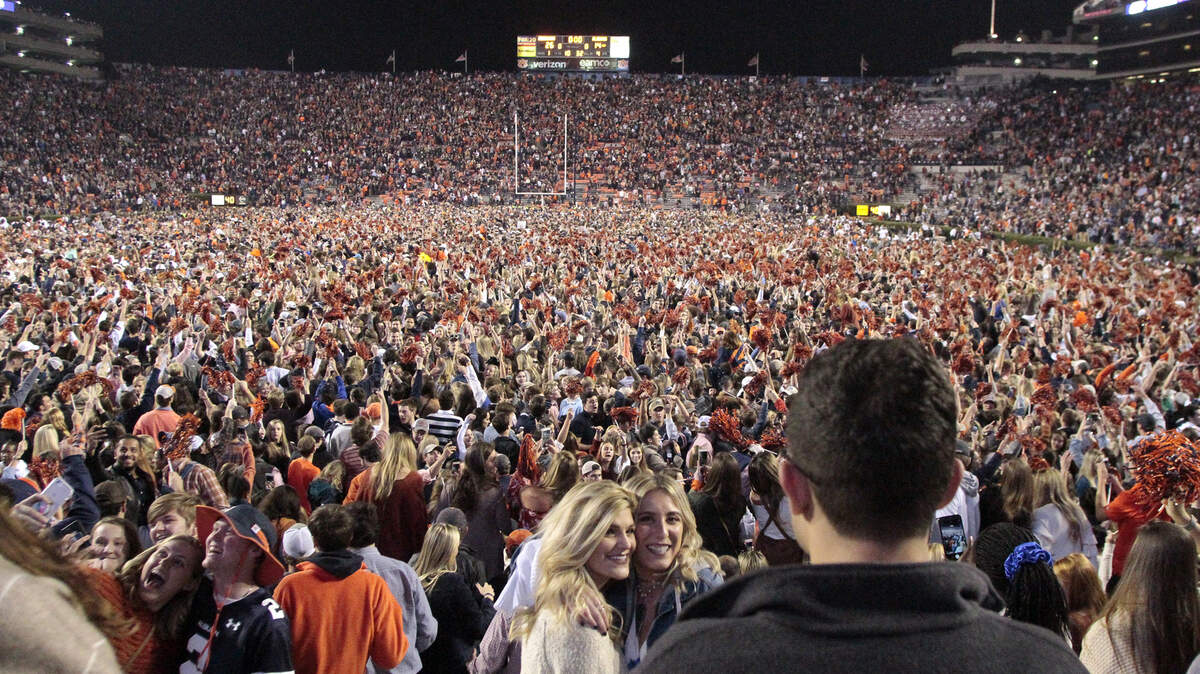 Students storm the field after Auburn upset Alabama 26-14 in the Iron Bowl at Jordan-Hare Stadium.