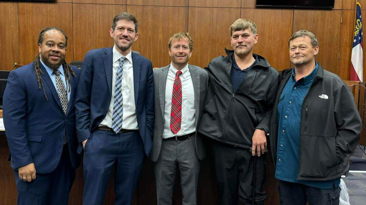 Lawyer Chris Breault (center) stands with Jonathon Wright (right center) in court after Wright won a major settlement. Also pictured are lawyers Shevon Thomas II (far left) and Christopher Newbern (left center).