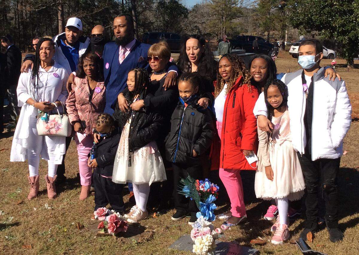 The family of Kamarie Holland gathers at her gravesite Wednesday morning after a funeral service at Taylor Funeral Home in Phenix City, Alabama.