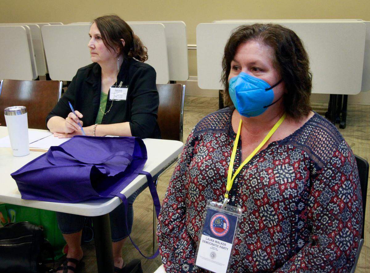 Jodi Deane,left, a poll watcher for the Republican party, and Laura Walker,right, a poll watcher for the Democratic party, observe voting at voting precinct 102 at the Columbus Public Library, 3000 Macon Road, in Columbus, Georgia on Tuesday morning. 11/08/2022