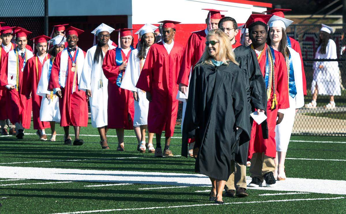 Ronie Collins, president of St. Anne-Pacelli Catholic School in Columbus, Georgia, leads the school’s 2021 graduating class during the school’s graduation ceremony. Collins has announced recently her retirement. 02/28/2024