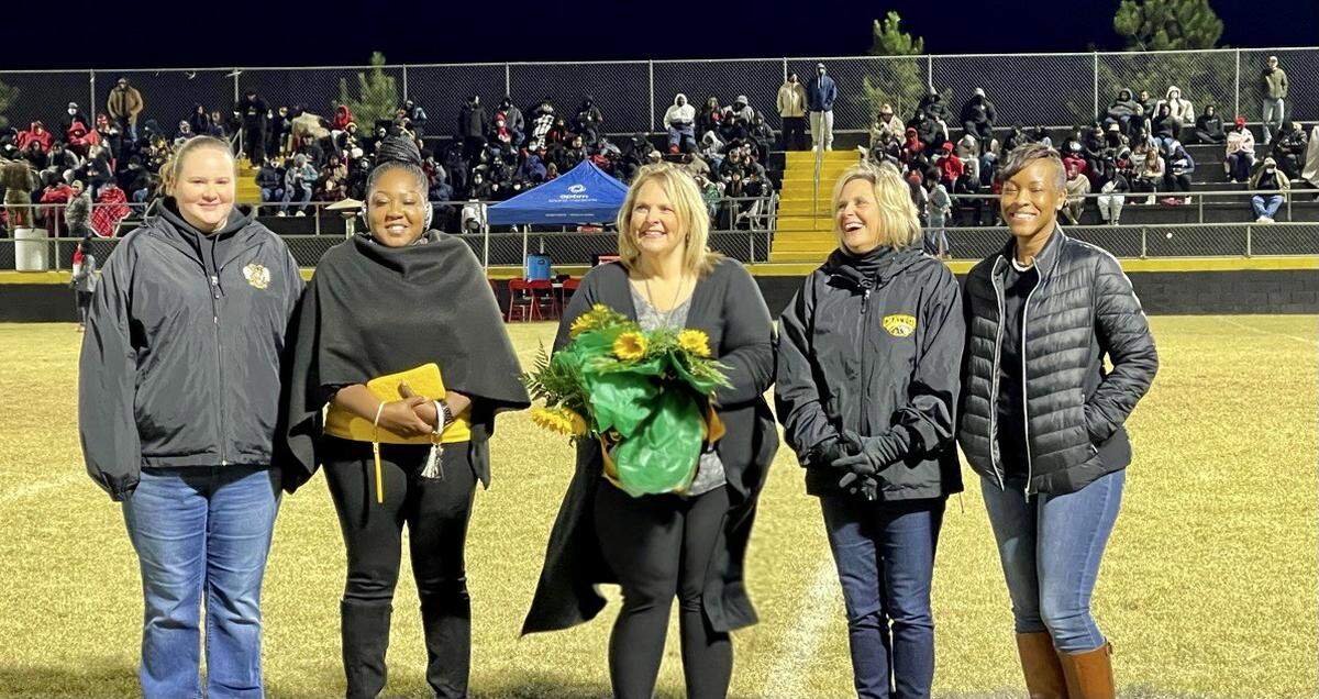 During halftime of its high school Nov. 5, 2021, football game, the Chattahoochee County School District honored its Teachers and Support Persons of the Year. Pictured, from left, are: bookkeeper and administrative assistant Amanda Williamson, the Chattahoochee County Education Center and District Support Person of the Year; receptionist Kimberly Rembert, the Chattahoochee County Middle and High School Support Person of the Year.; ChattCo superintendent Kristie Brooks; English language arts teacher Kimberlie Walker, the CCMHS and District Teacher of the Year; and prekindergarten teacher Charlotte Richards, the CCEC Teacher of the Year.