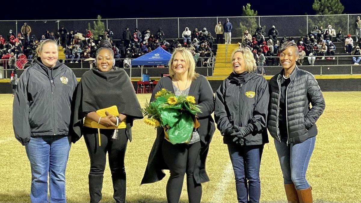 During halftime of its high school Nov. 5, 2021, football game, the Chattahoochee County School District honored its Teachers and Support Persons of the Year. Pictured, from left, are: bookkeeper and administrative assistant Amanda Williamson, the Chattahoochee County Education Center and District Support Person of the Year; receptionist Kimberly Rembert, the Chattahoochee County Middle and High School Support Person of the Year.; ChattCo superintendent Kristie Brooks; English language arts teacher Kimberlie Walker, the CCMHS and District Teacher of the Year; and prekindergarten teacher Charlotte Richards, the CCEC Teacher of the Year.