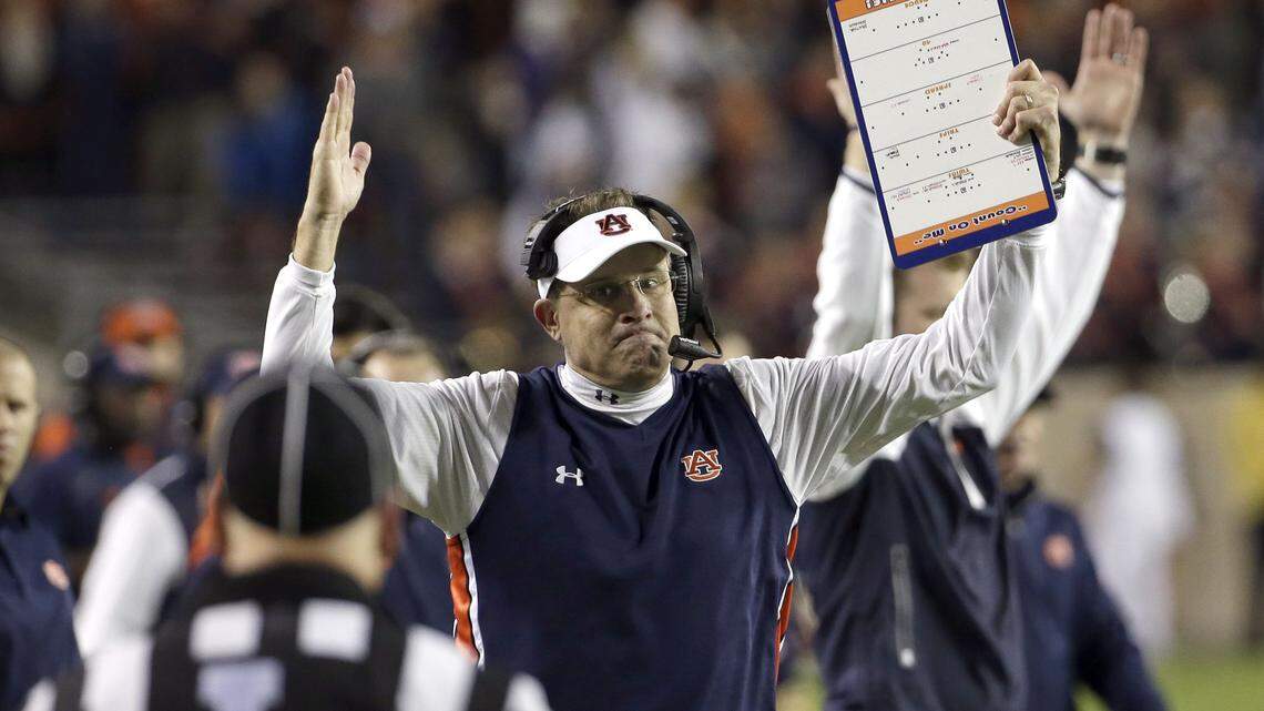 Auburn coach Gus Malzahn signals a touchdown as he looks at an official during the second quarter of an NCAA college football game against Texas A&M Saturday, Nov. 7, 2015, in College Station, Texas. Officials reviewed the play and changed the ruling on the field to a touchdown. (AP Photo/David J. Phillip)