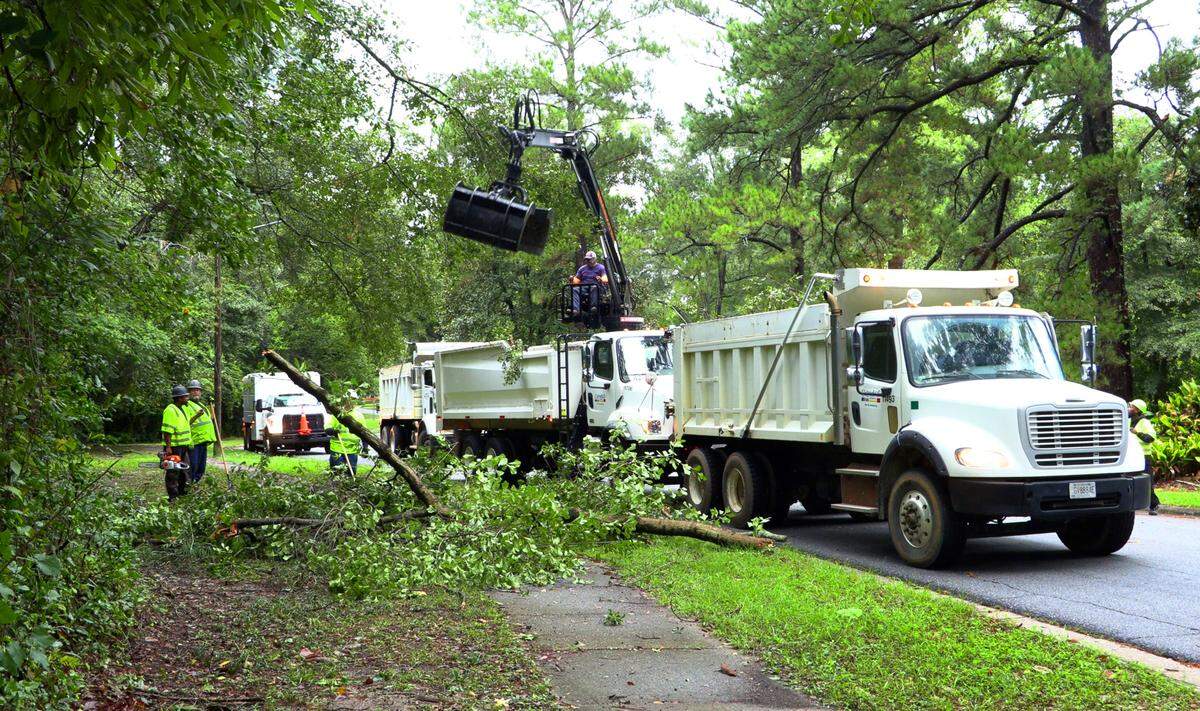 A city work crew removes fallen tree limbs along East Lindsay Drive in Columbus, Georgia on Friday morning. 09/27/2024