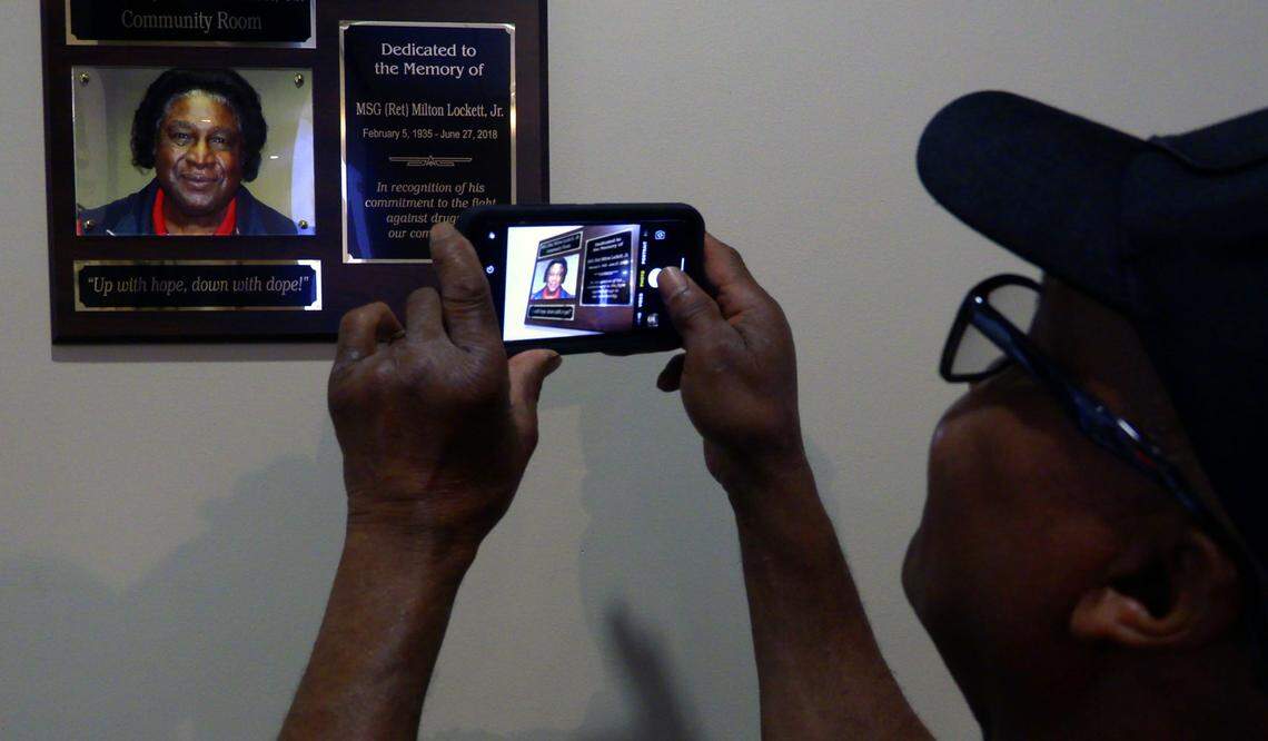 Lewis Kemp Jr. takes a photograph of a plaque honoring retired U.S. Army Master Sgt. Milton Lockett Jr. Thursday morning in the room at the Columbus Public Safety Center in Columbus that is now named in Lockett’s honor. The Columbus Police Department renamed and dedicated the community room at the Public Safety Center Thursday in memory of the longtime community activist who helped fight the war on drugs. The name of retired Master Sgt. Milton Lockett Jr., who helped found what is now Columbus Against Drugs Inc. in Columbus, Georgia, now spans the doorway to the room, used for a variety of events. Lockett died June 27, 2018 and was buried at Ft. Benning’s Main Post Cemetery with full military honors. Go to www.ledger-enquirer.com for more from the event.