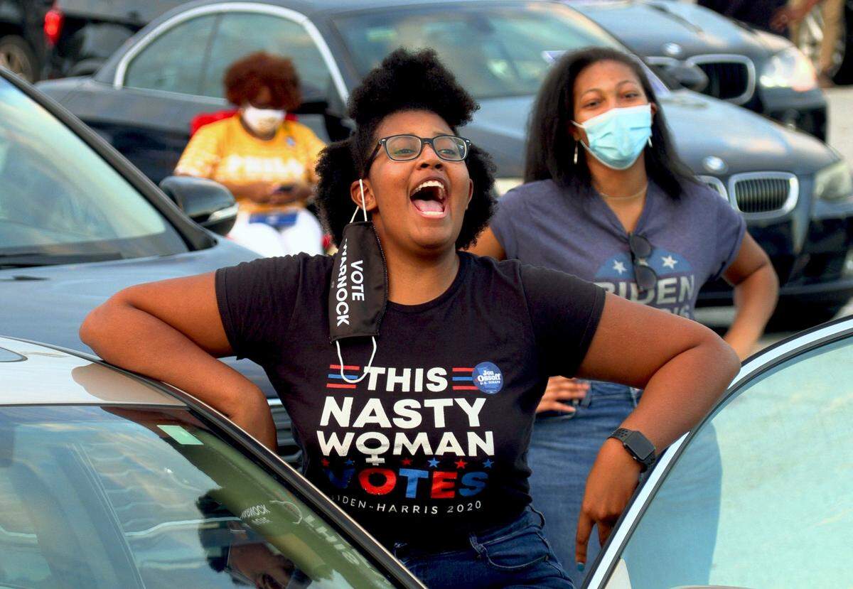 People gather Wednesday evening in the parking lot of the Columbus Civic Center in Columbus, Georgia for a political rally featuring Jon Ossoff.