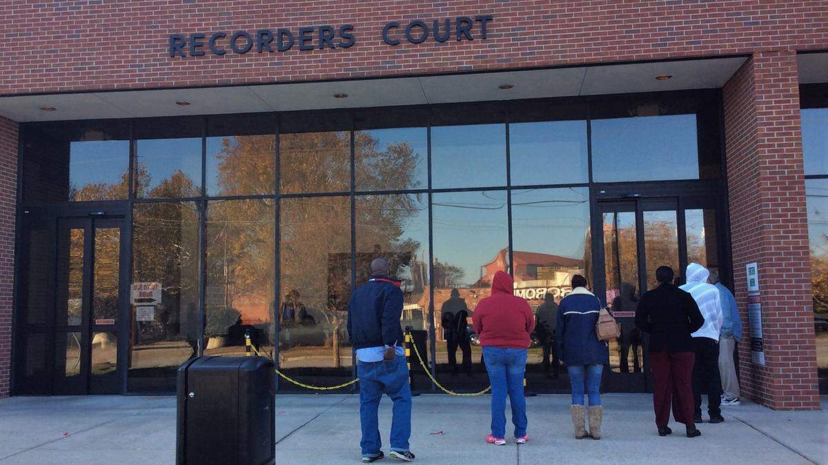 People summoned to court line up outside the Recorder’s Court building at 702 10th St. on Dec. 8, 2020.