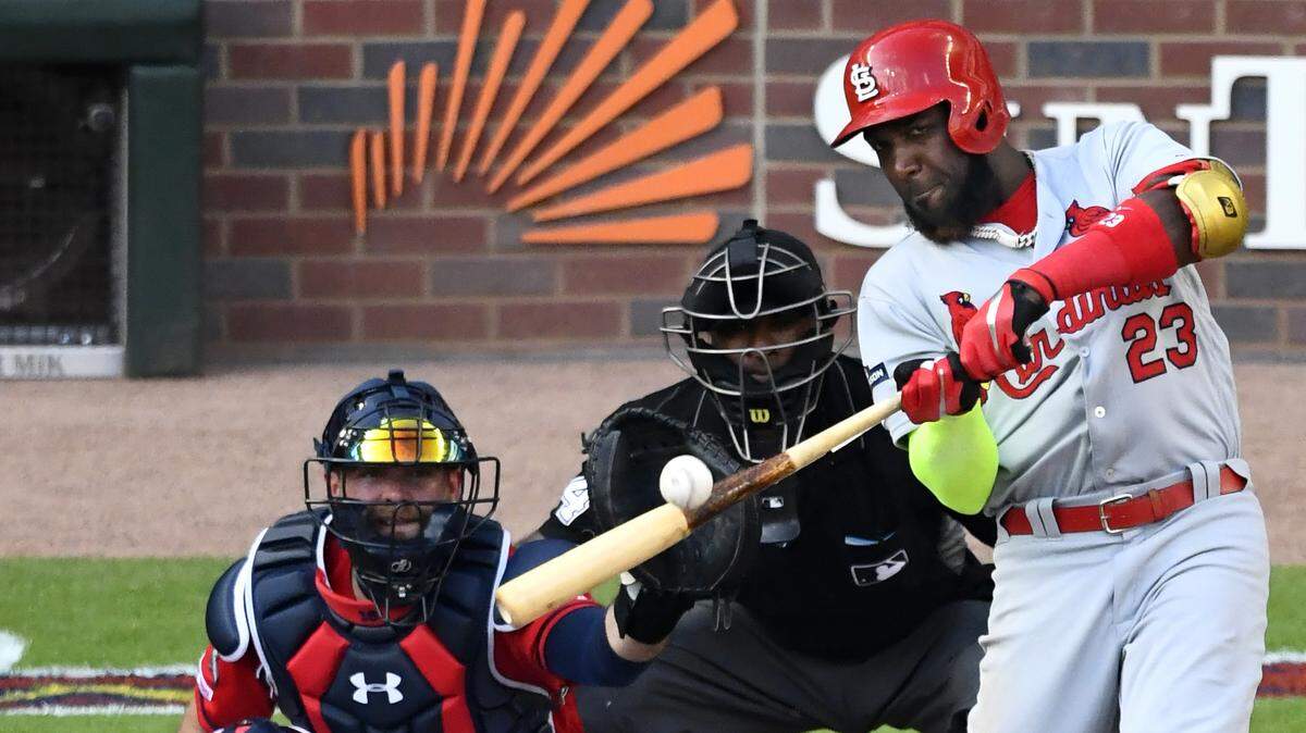 FILE - In this Friday, Oct. 4, 2019 file photo, St. Louis Cardinals left fielder Marcell Ozuna (23) hits a single against the Atlanta Braves in the fourth inning during Game 2 of a best-of-five National League Division Series in Atlanta. Free agent outfielder Marcell Ozuna and the Atlanta Braves reached an $18 million, one-year deal Tuesday, Jan. 21, 2020 that puts him on the team he helped beat in the playoffs last October.