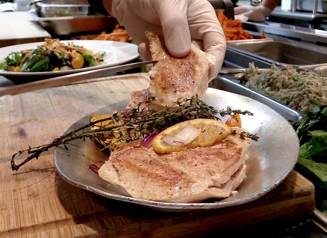 Epic Restaurant Chef Jamie Keating prepares the Grilled Pecan Chicken Salad, one of five lunch entrees for Restaurant Week 2018.