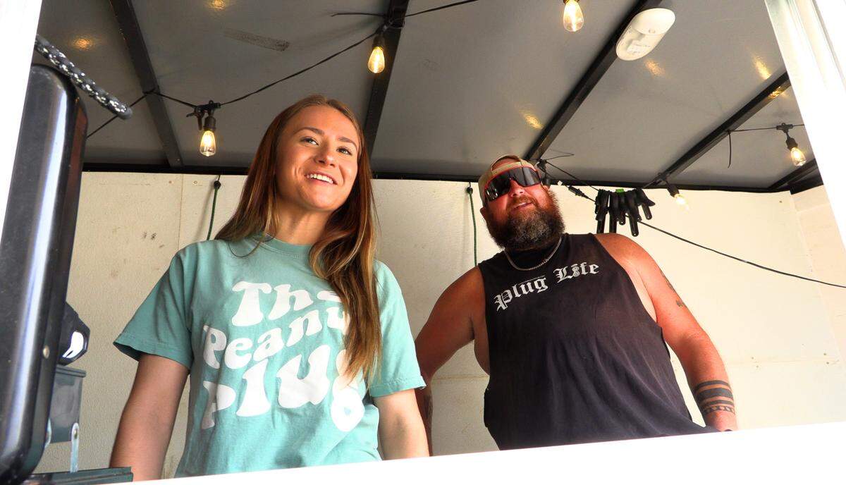 Matthew Cato, owner of The Peanut Plug, and his daughter Kaydence, greet a customer on Feb. 5, 2025.