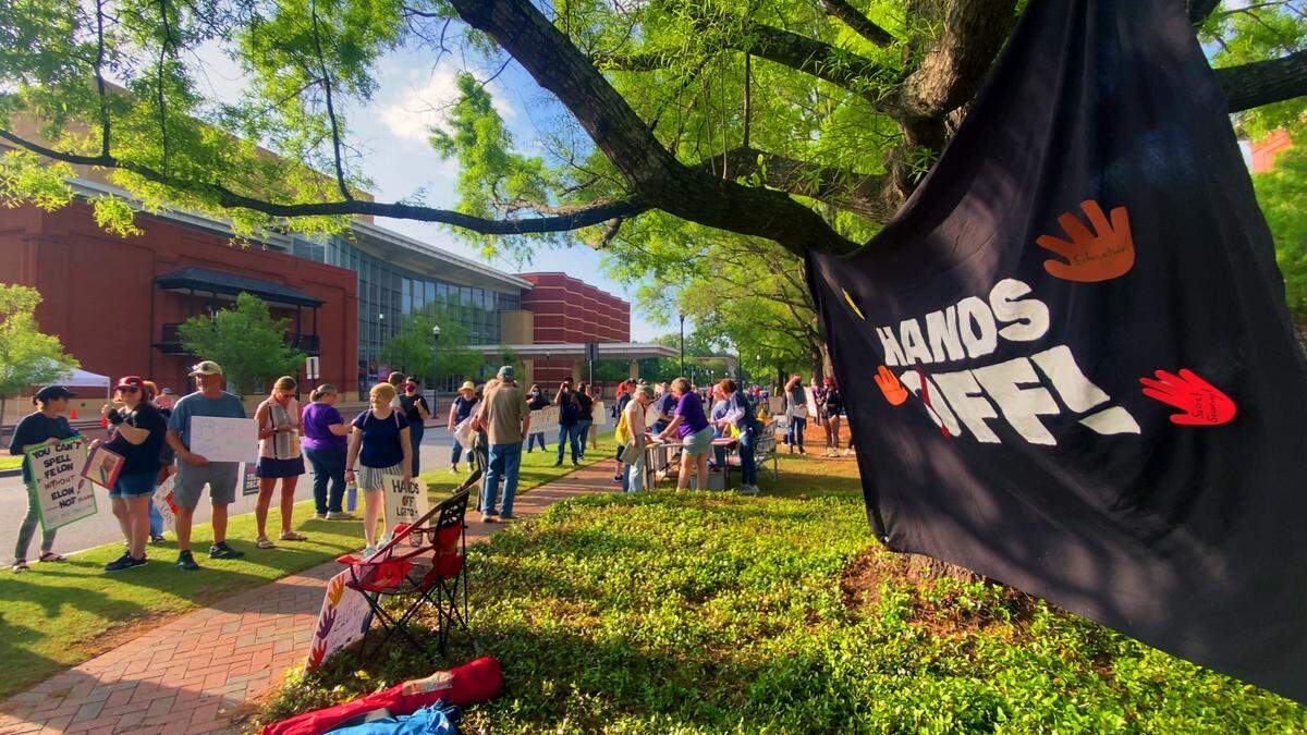 Participants in a “Hands Off” rally hosted by Indivisible Columbus gather prior to the start of the rally Saturday morning in downtown Columbus, Georgia. 04/05/2025