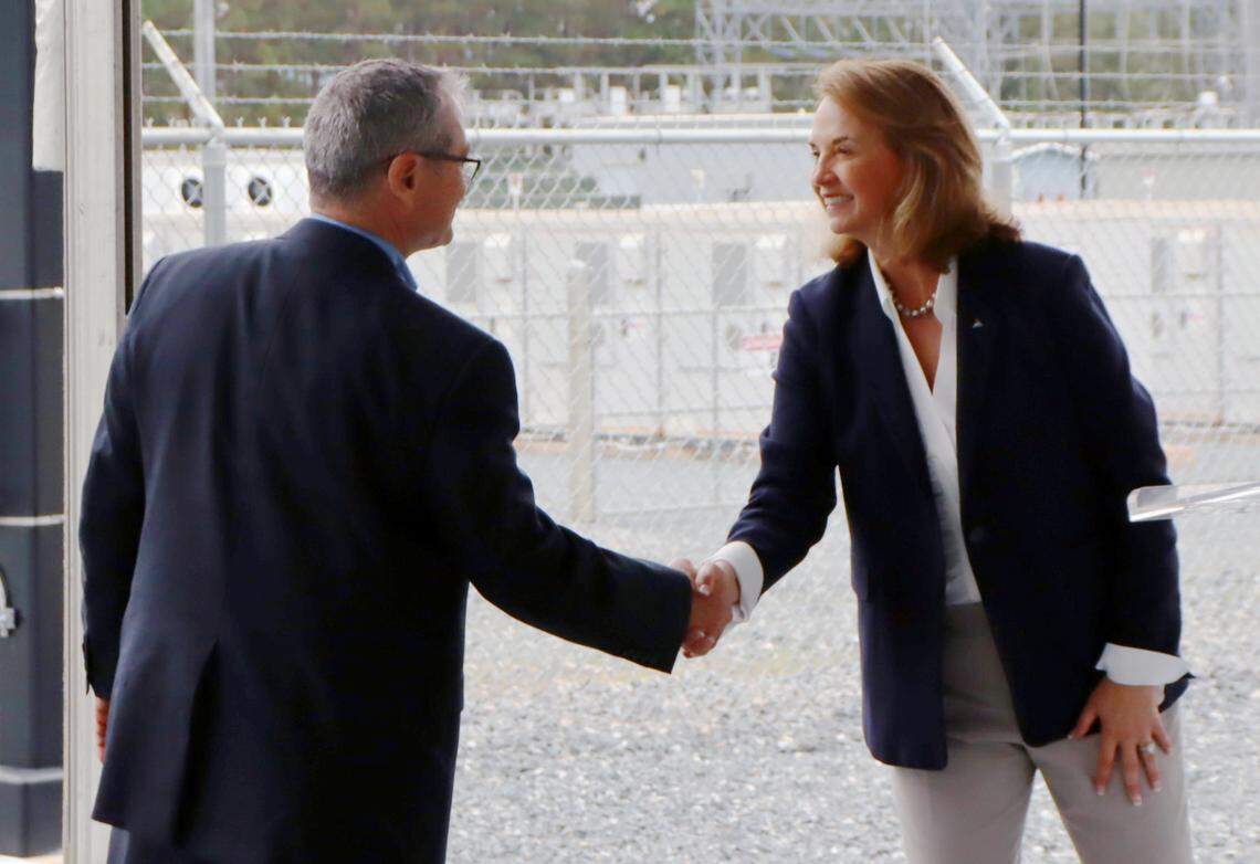 Tim Echols, Public Service commissioner, shakes hands with Kim Greene, CEO/President of Georgia Power, at the opening of the Mossy Branch Energy Facility in Talbot County. 11/07/2024