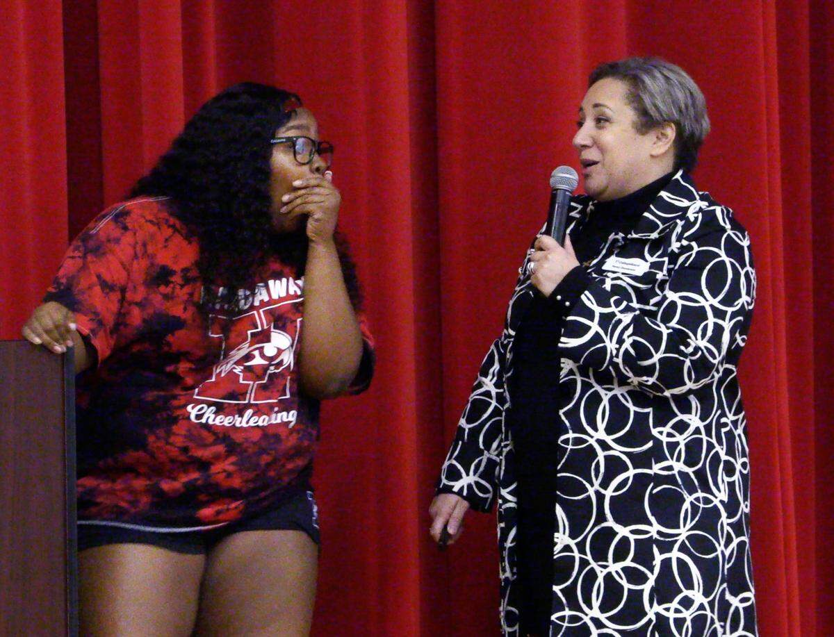 Hardaway High School senior E’lyssia Brown, left, reacts after Penny Damianeas, the College Board’s state and district partnerships director, far left, announced E’lyssia is the recipient of a $40,000 scholarship. 01/19/2023
