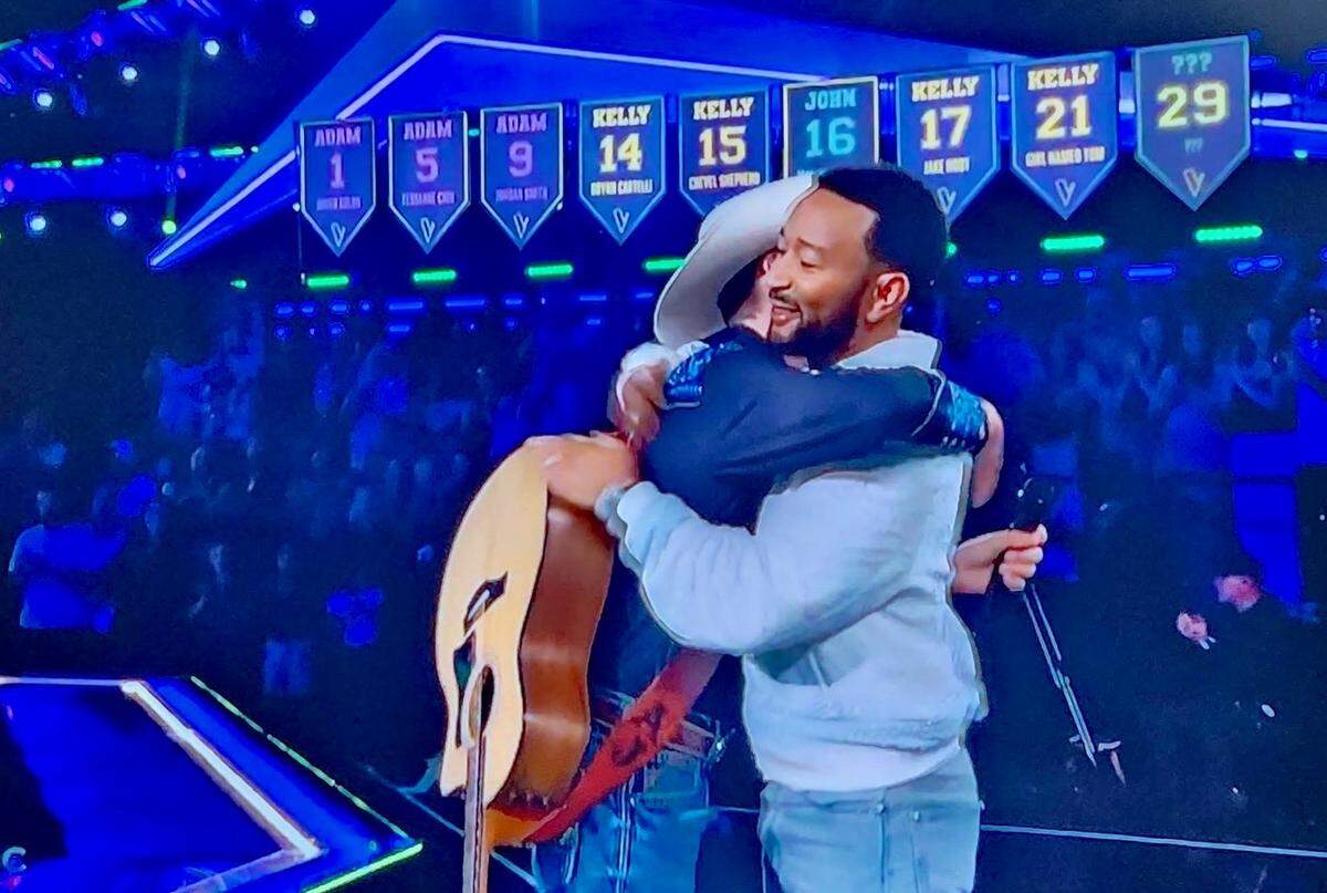 AJ Robinson of Cataula in Harris County, a ninth-grader at Calvary Christian School in Columbus, hugs John Legend at Universal Studios in Hollywood, California, where Legend selected AJ for his team after AJ performed during the Feb. 23, 2026, episode of the singing competition TV show “The Voice” on NBC.
